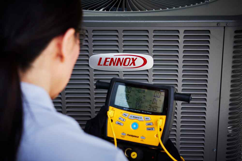 Technician testing Lennox HVAC unit performance