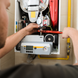 Technician fixes a gas furnace 